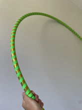 Load image into Gallery viewer, Green and gold hula hoop held by a hand for sale in nz