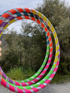 selection of rainbow hula hoops outside