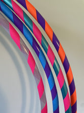 Load image into Gallery viewer, Colourful hula hoop with pink, blue, and purple grip tape
