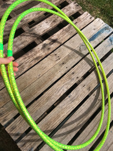 two lime green hula hoops with holographic tape pictured on a pallet 