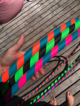 Load image into Gallery viewer, hula hoops in three colour combinations; pink, green, black, turquoise and orange
